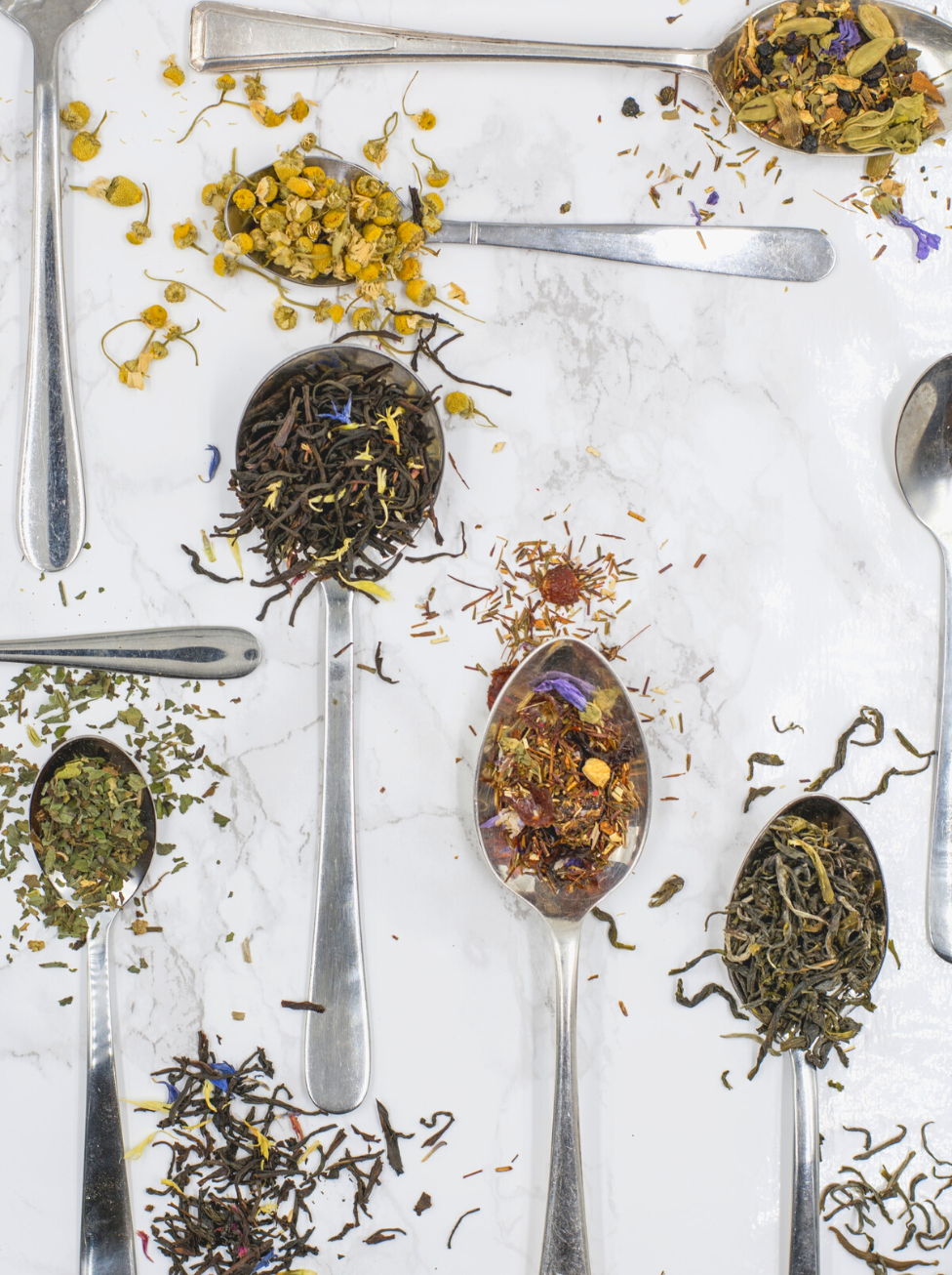 spoons full of herbs including yerba mate and ginkgo biloba