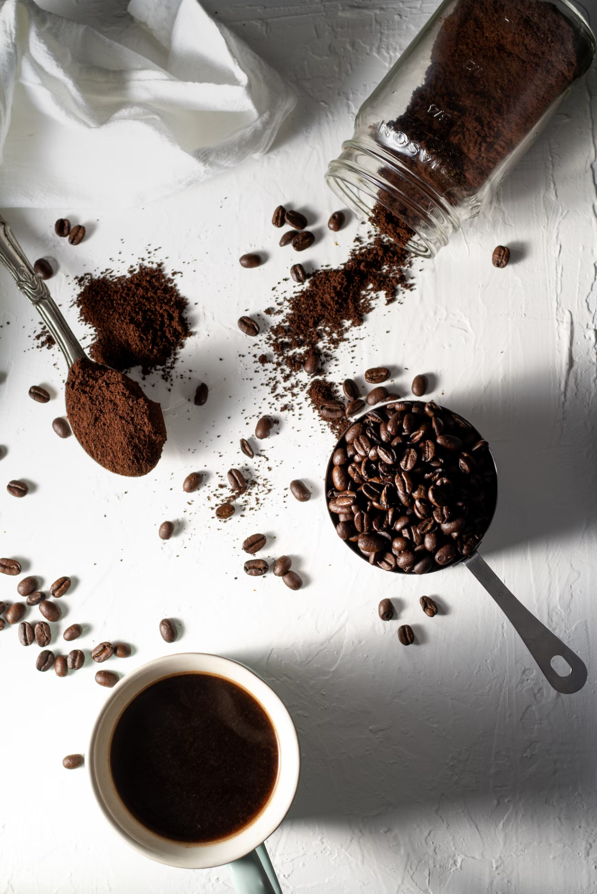 coffee beans on table next to black americano