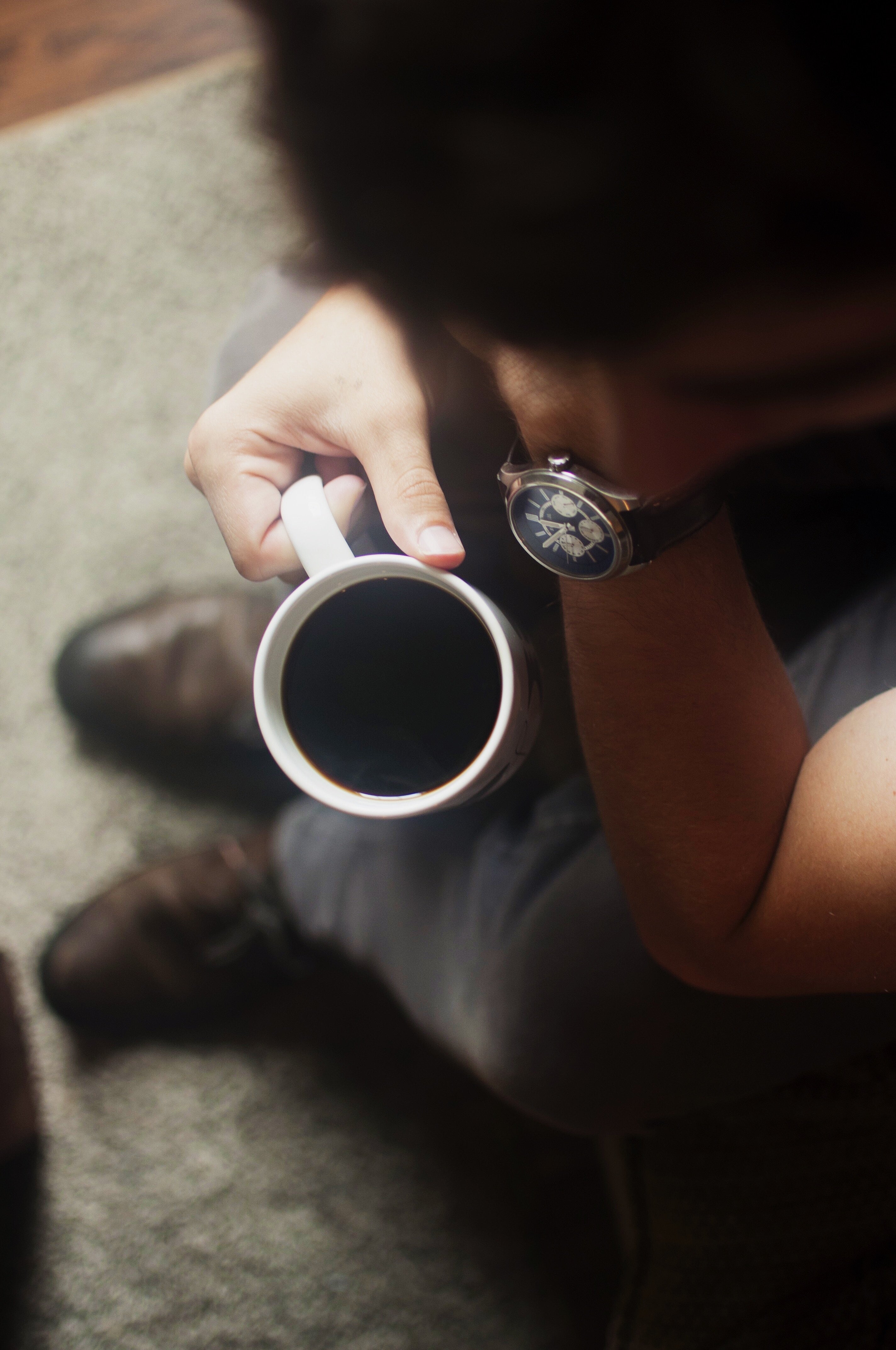 man drinking coffee looking distressed